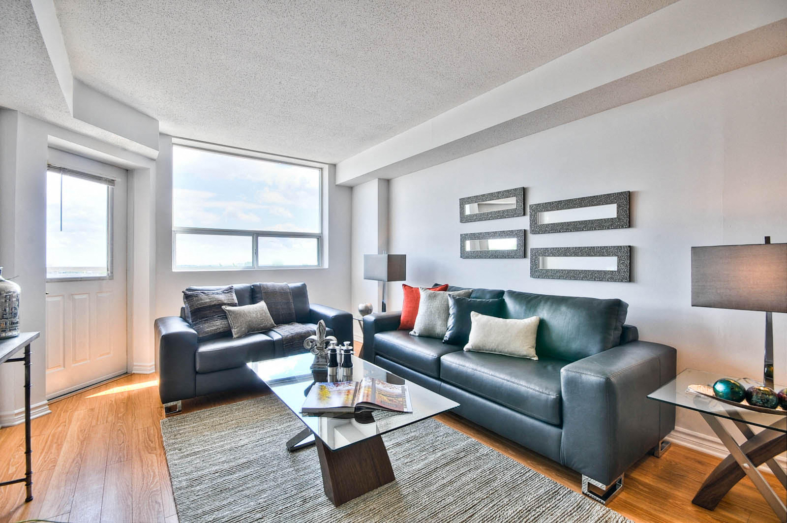 a living room with leather couches and a coffee table